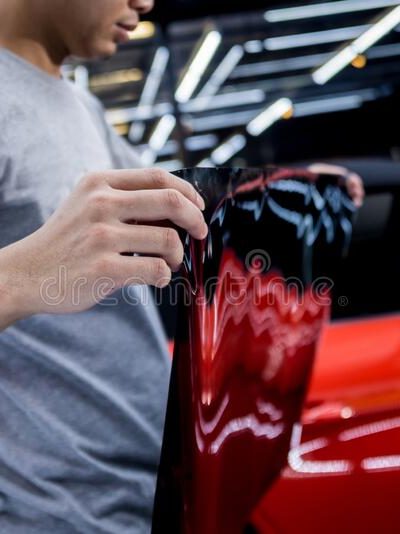 applying-tinting-foil-car-window-auto-service-red-background-187756535